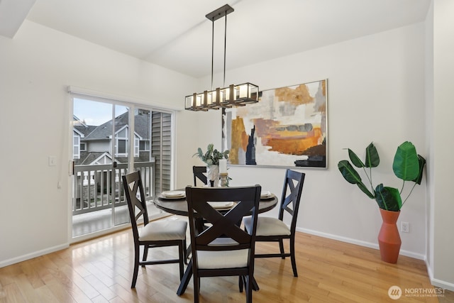 dining room with baseboards and light wood-style floors