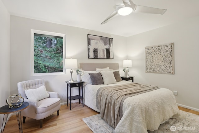 bedroom featuring light wood-type flooring, a ceiling fan, and baseboards