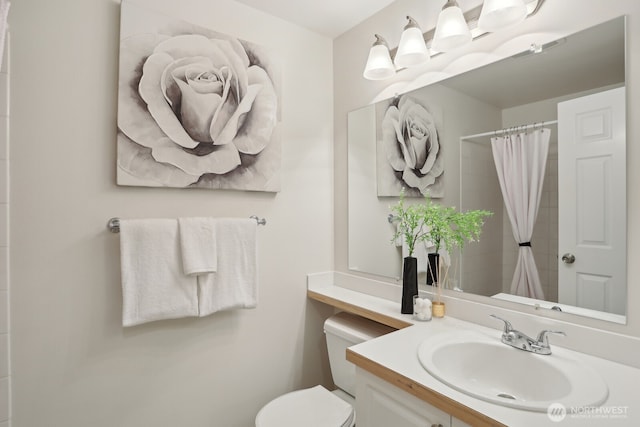 bathroom with toilet, curtained shower, and vanity