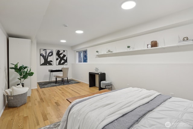 bedroom with baseboards, wood finished floors, and recessed lighting