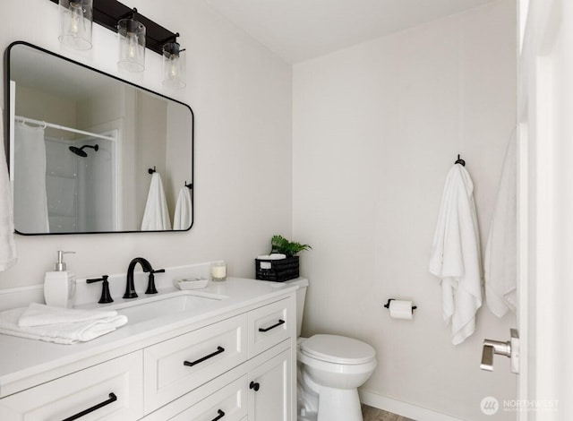 bathroom featuring curtained shower, vanity, and toilet