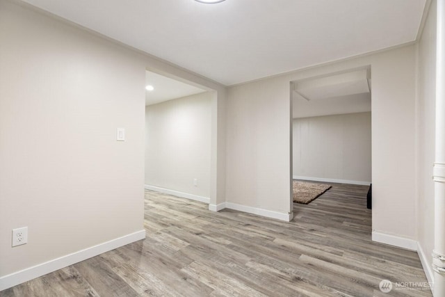 empty room featuring baseboards and wood finished floors