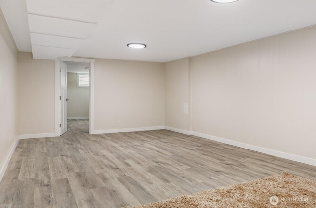 empty room with baseboards and wood finished floors