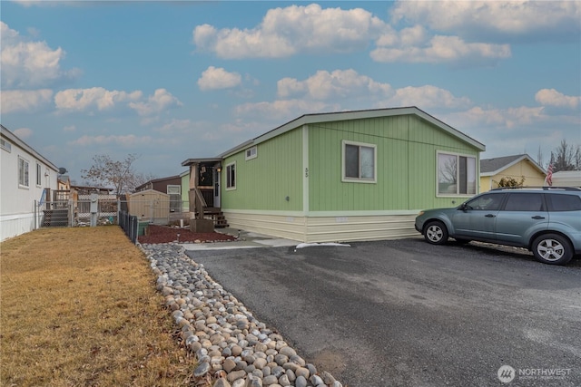 view of front of home featuring fence and a residential view