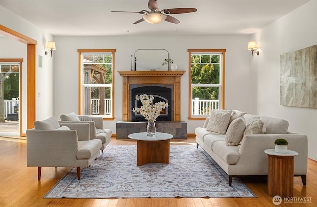 living area with a wealth of natural light and hardwood / wood-style floors