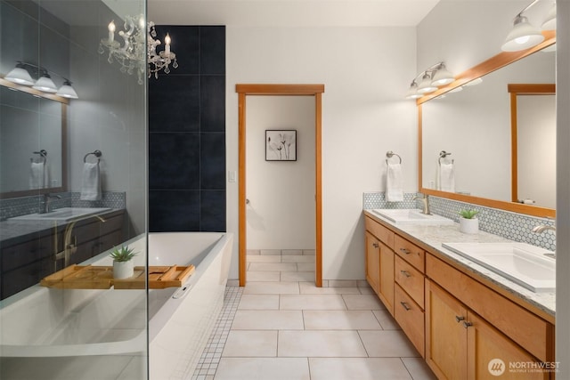 bathroom with tasteful backsplash, a sink, and double vanity