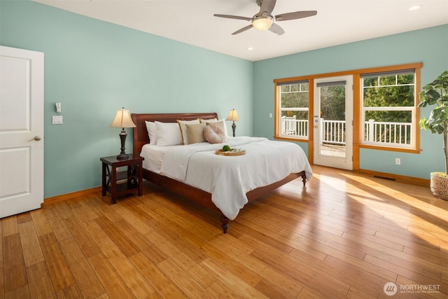 bedroom with access to outside, light wood finished floors, visible vents, and baseboards