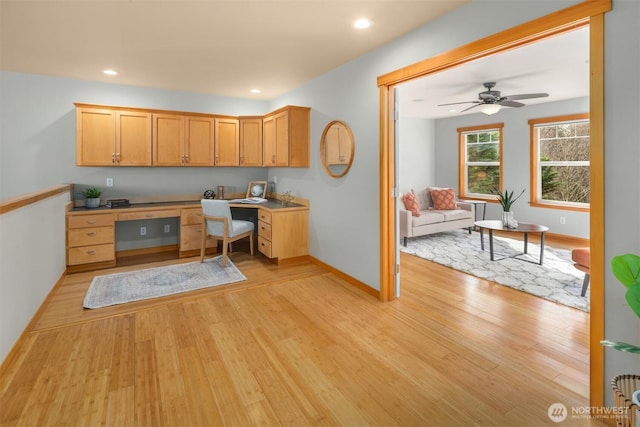 office featuring recessed lighting, light wood-style flooring, a ceiling fan, built in study area, and baseboards