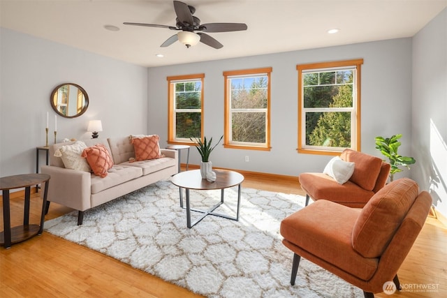 living room with a ceiling fan, recessed lighting, baseboards, and wood finished floors