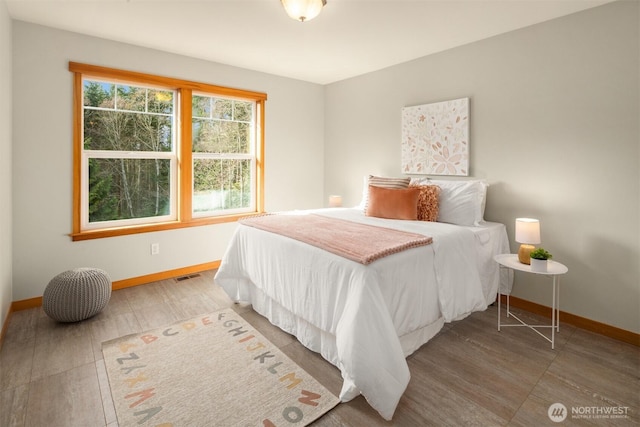 bedroom with baseboards, multiple windows, and visible vents