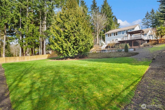 view of yard with fence and a deck