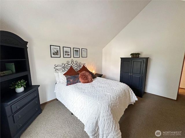 carpeted bedroom with lofted ceiling and baseboards