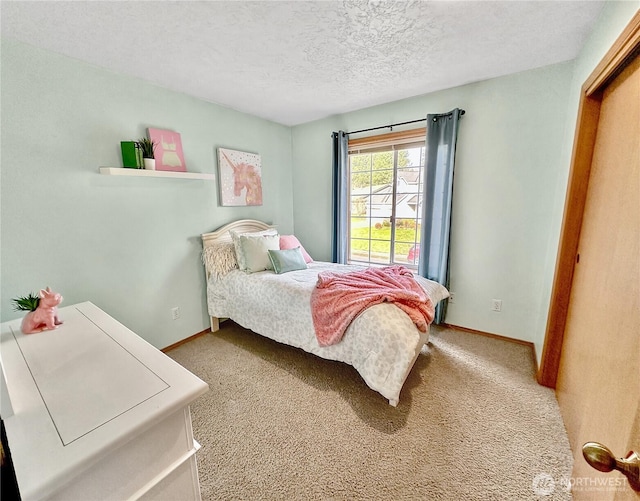 bedroom featuring carpet floors, a textured ceiling, and baseboards