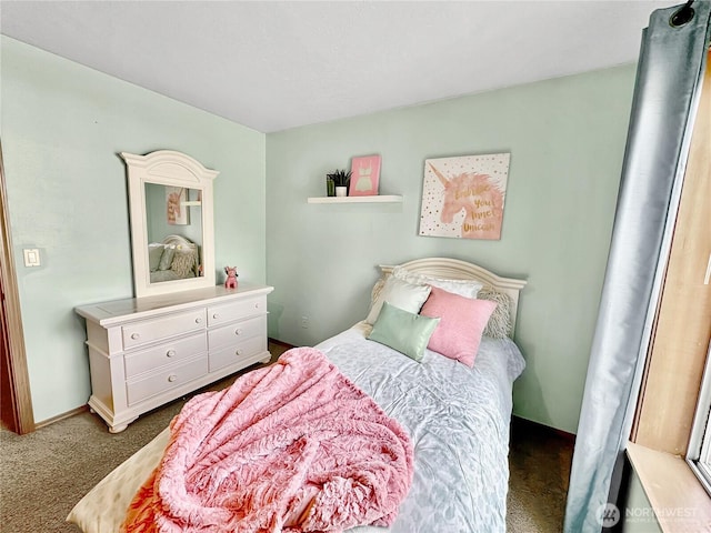 carpeted bedroom featuring baseboards