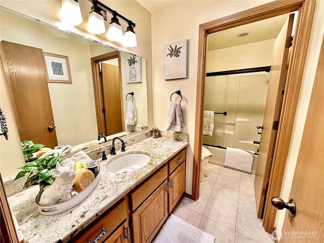 full bathroom with toilet, tile patterned flooring, bathing tub / shower combination, and vanity