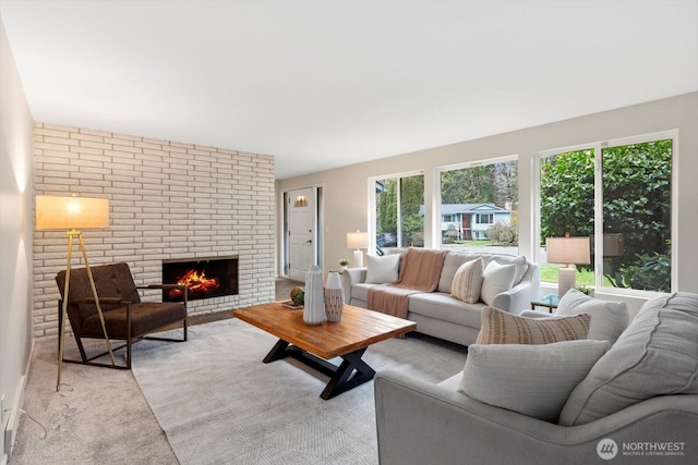 living room featuring light carpet and a fireplace