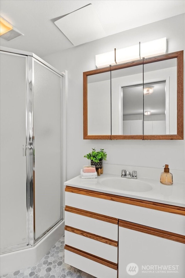 bathroom featuring a stall shower and vanity