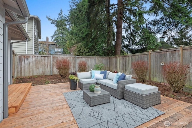 view of patio with a deck, an outdoor hangout area, and a fenced backyard