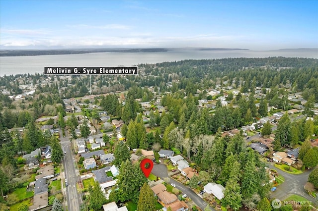 drone / aerial view with a water view and a residential view