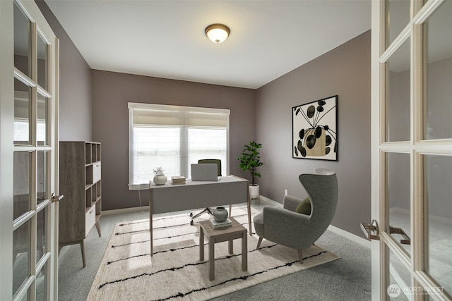 carpeted home office featuring french doors, baseboards, and a healthy amount of sunlight