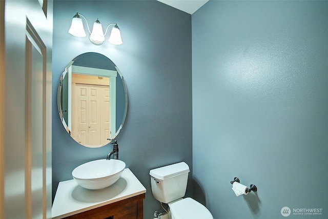 half bath featuring toilet and vanity