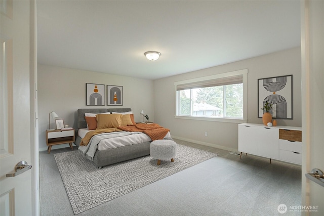 carpeted bedroom featuring baseboards