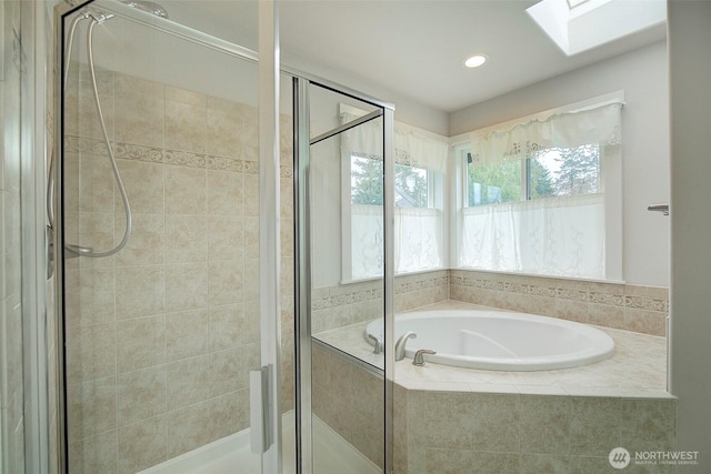 bathroom with a shower stall, a skylight, a bath, and recessed lighting