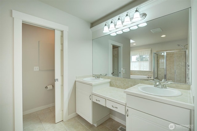 full bathroom with a garden tub, a sink, a shower stall, tile patterned flooring, and double vanity