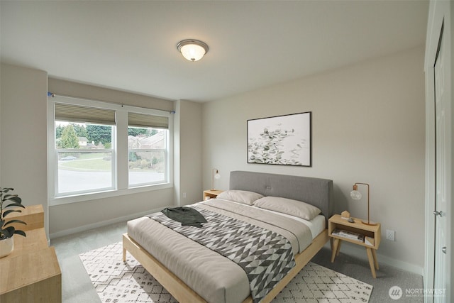 bedroom with carpet flooring and baseboards