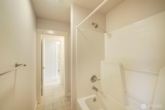 full bath with tile patterned floors and washtub / shower combination