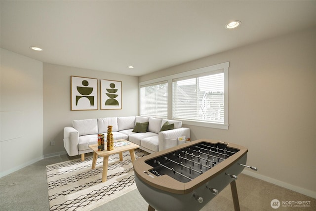 carpeted living area with recessed lighting and baseboards