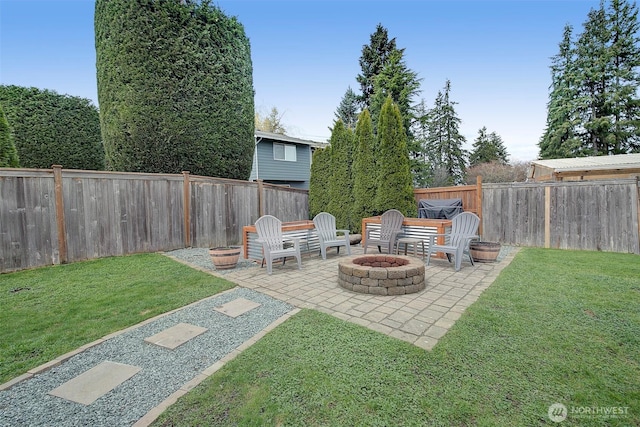 view of yard featuring a patio, a fenced backyard, and an outdoor fire pit