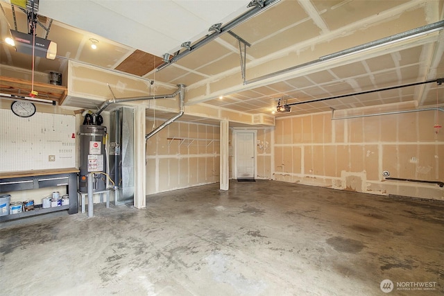 garage featuring strapped water heater and a garage door opener