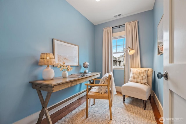 office space with baseboards, visible vents, and light wood finished floors