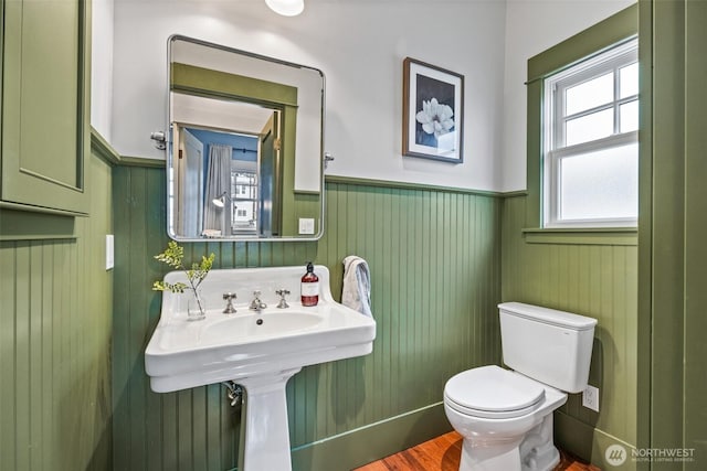 bathroom featuring toilet and wainscoting