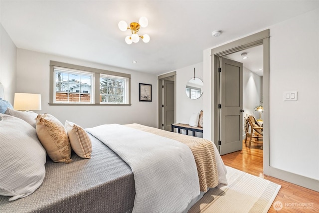 bedroom featuring light wood-style flooring and baseboards