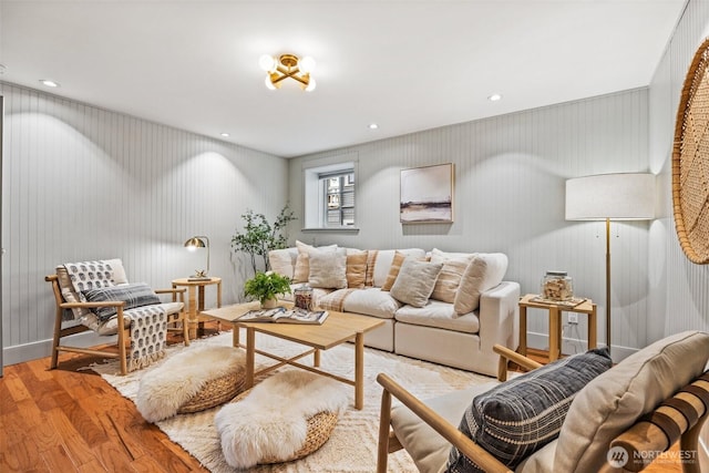 living room with baseboards, wood finished floors, and recessed lighting