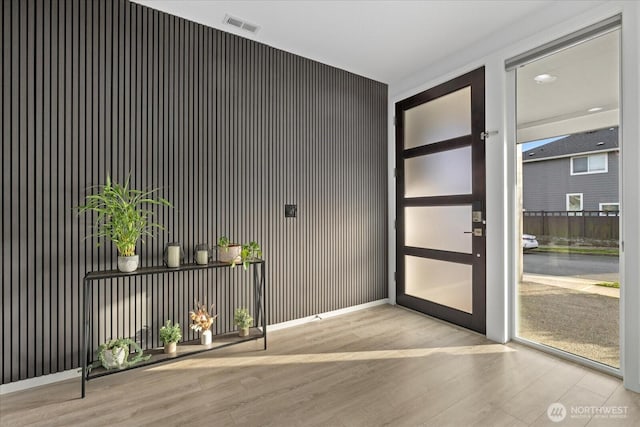 entryway with wood finished floors and visible vents