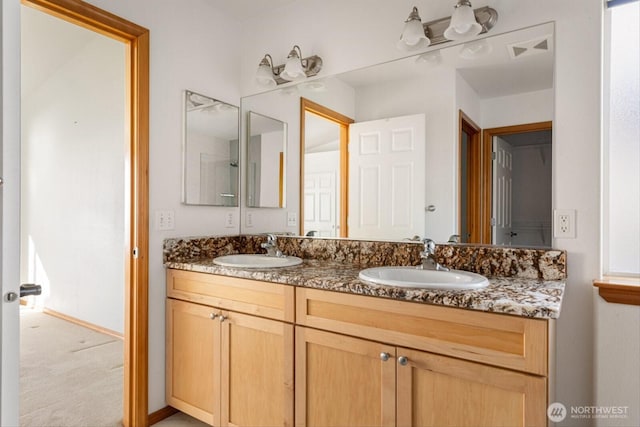 full bathroom featuring double vanity, visible vents, and a sink