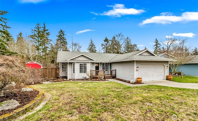 single story home with a garage, driveway, a front yard, and fence