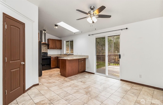 kitchen featuring brown cabinets, light countertops, black range with electric stovetop, wall chimney range hood, and a peninsula