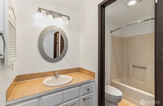 bathroom featuring tub / shower combination, vanity, and toilet