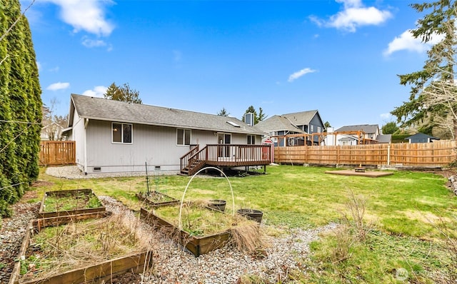 back of house with a wooden deck, a vegetable garden, a fenced backyard, crawl space, and a yard