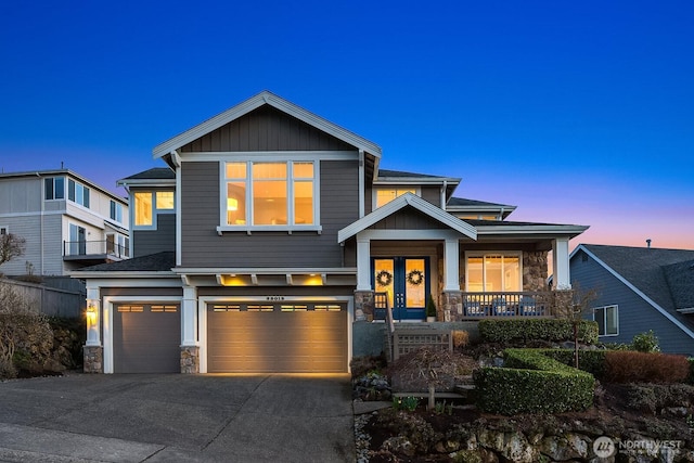 craftsman-style house with a garage, stone siding, a porch, and concrete driveway