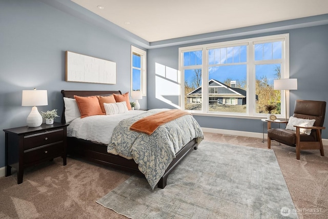 carpeted bedroom featuring baseboards