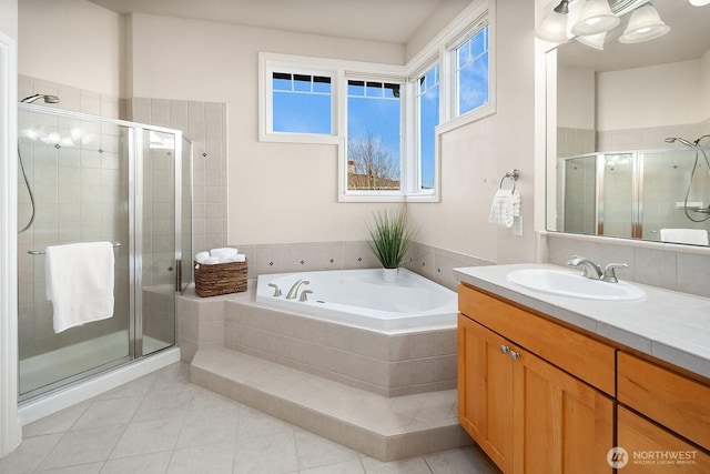 bathroom featuring a stall shower, a garden tub, vanity, and tile patterned floors