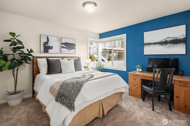 bedroom featuring baseboards and light colored carpet