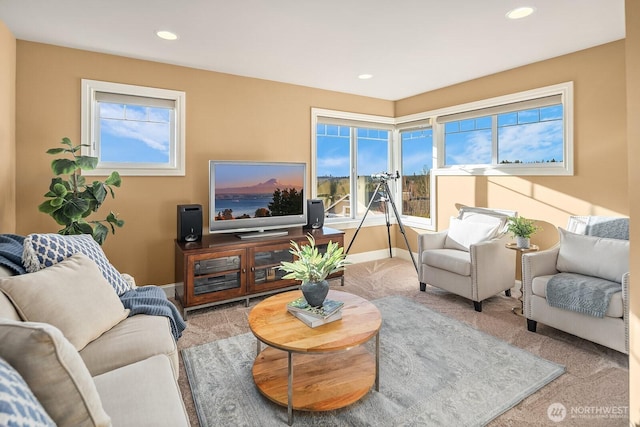 carpeted living room featuring a healthy amount of sunlight, baseboards, and recessed lighting