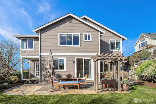 back of property with a yard, a patio area, and a pergola