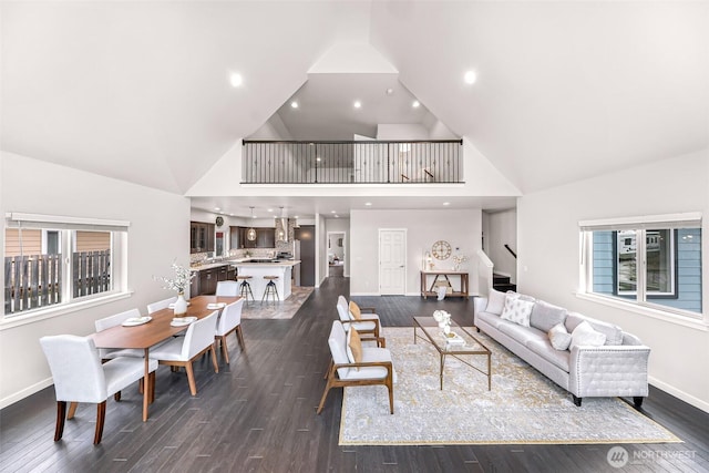 living area featuring recessed lighting, dark wood finished floors, baseboards, and stairs